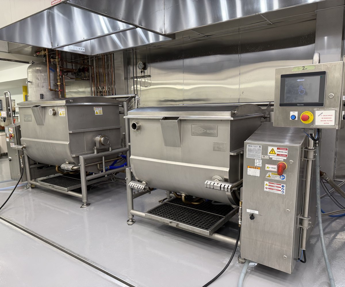 Jacketed steam kettles with touchscreen controls on the Oakland production floor
