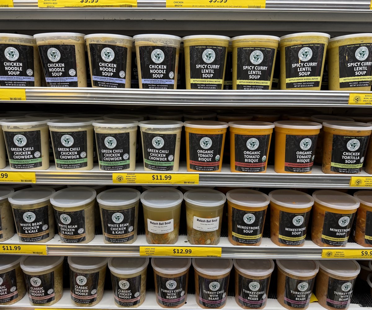 Retail soup tubs faced on a refrigerated grocery shelf