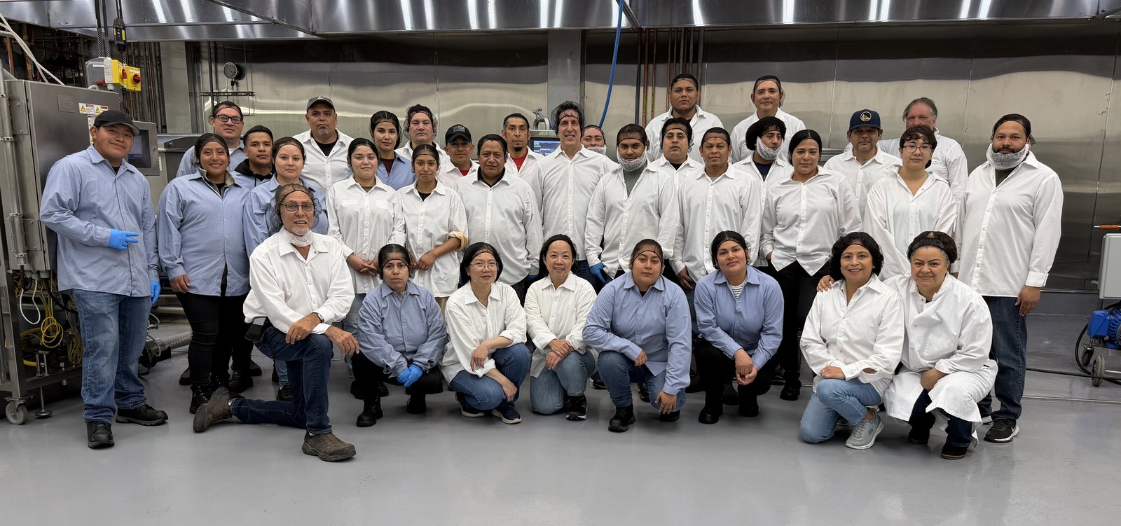 The Ladle & Leaf production team gathered on the plant floor in Oakland